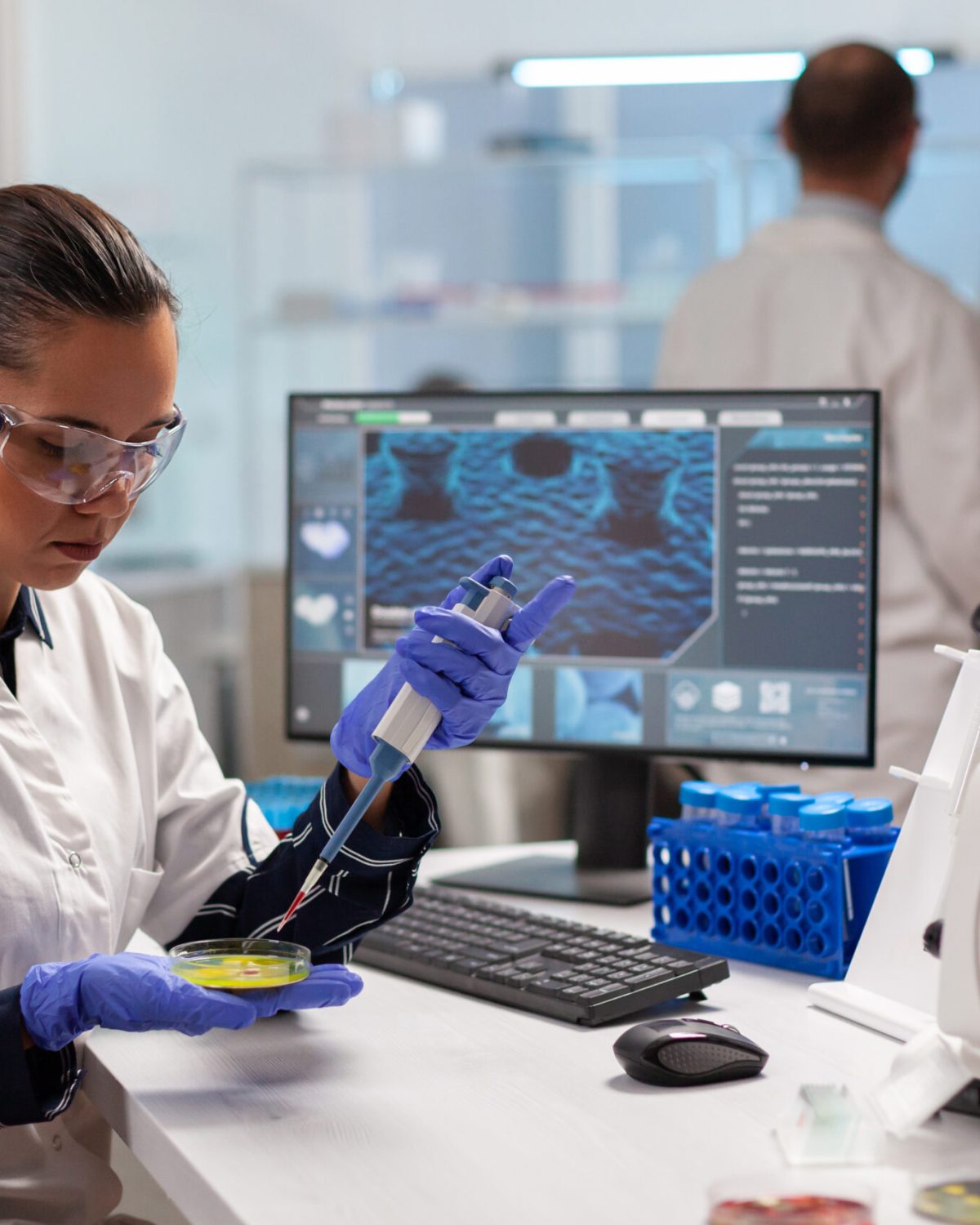 Doctor scientist conducting clinical experiment using micropipette with blood sample. Medical stuff examining vaccine evolution using high tech and technology researching treatment, development.